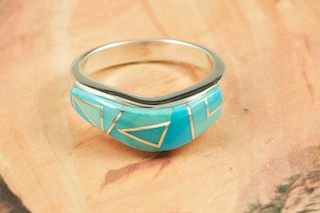 Genuine Sleeping Beauty Turquoise inlaid between ribbons of  Sterling Silver.  The Sleeping Beauty Turquoise mine is located in Gila County, Arizona. Beautiful Ring Designed  by Navajo Artist Calvin Begay. Signed.